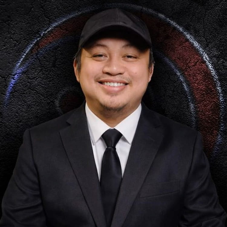 Stone sculpture of reclining figure with child outdoors